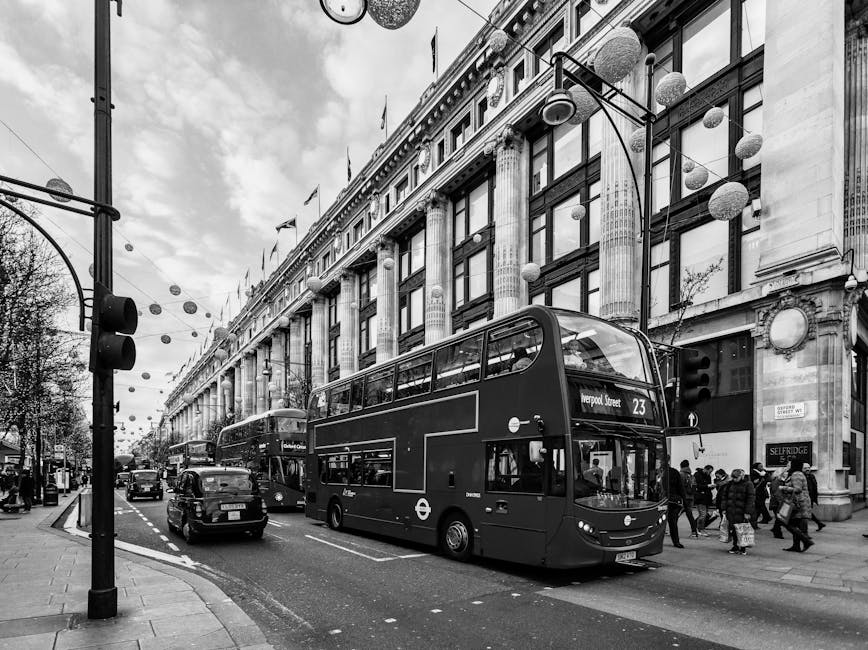 Black and white photo of London's bustling street featuring iconic double decker